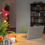 Home office setup for remote working, Cozy workplace with laptop, desk lamp and office supplies