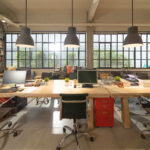 Empty coworking space modern office room. Building facility desk and table. Business community center architecture interior and design area in company.